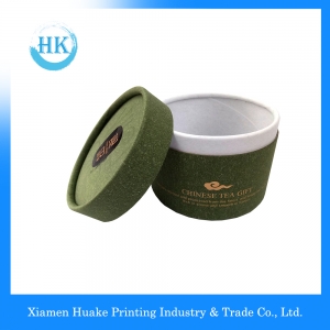 el oro impreso verde que sella el té que embala el tubo gris de la base del papel de tablero con el casquillo del tirón 
